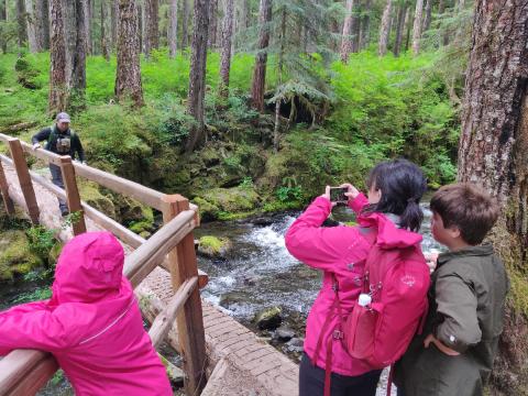 Tour participants cross over one of the many tributary bridges on the Lover's Lane trail in the Sol Duc