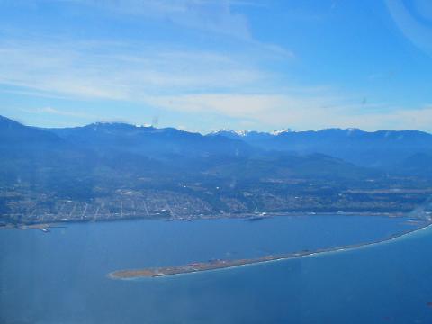 View of Port Angeles, the harbor, Ediz Hook, and the Olympic Mountains by air
