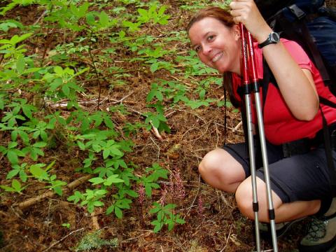 On a backpacking trip in Olympic National Park, Carolyn poses next to some odd-ball plants that do not photosynthesize